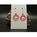 Pink machine embroidered circle with smaller circle inside earrings made of smaller loops. Gold hypoallergenic hooks.